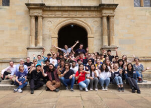 The photograph shows the whole group of participants in PROMYS Europe 2024, smiling and looking relaxed at Wadham College.