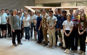 Andrew Wiles with students after his guest lecture 2023
